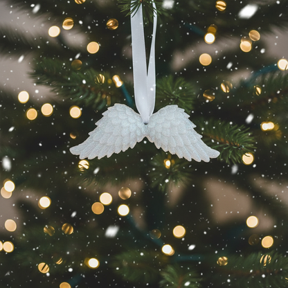 White glitter angel wings with festive background